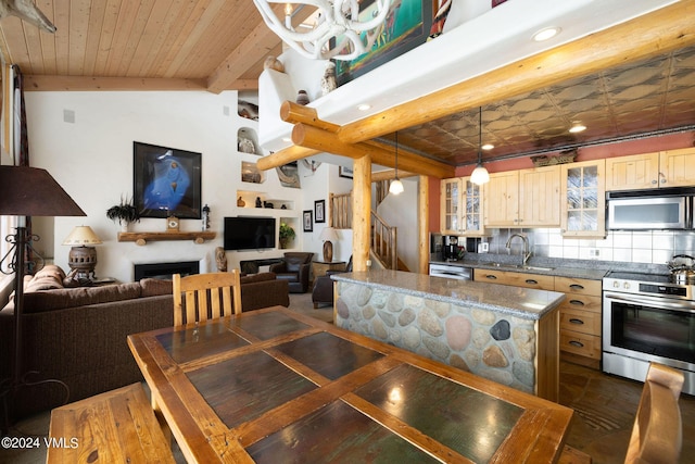 dining space with sink, wood ceiling, and lofted ceiling with beams