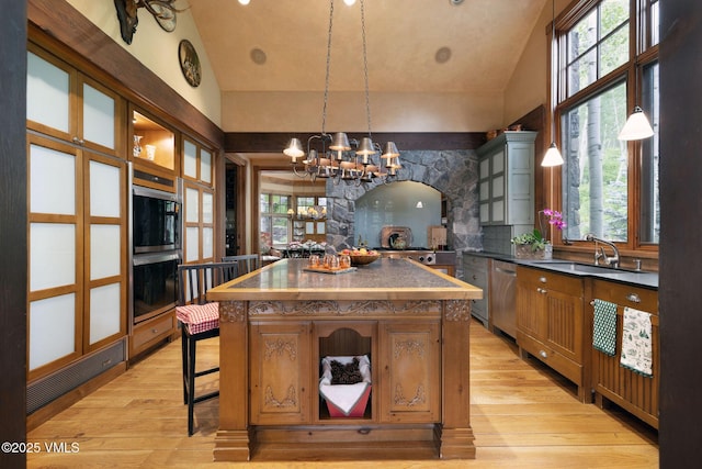 780 Potato Patch Dr, Vail, CO 81657 - kitchen featuring a chandelier, stainless steel appliances, dark countertops, lofted ceiling, and light wood-style floors