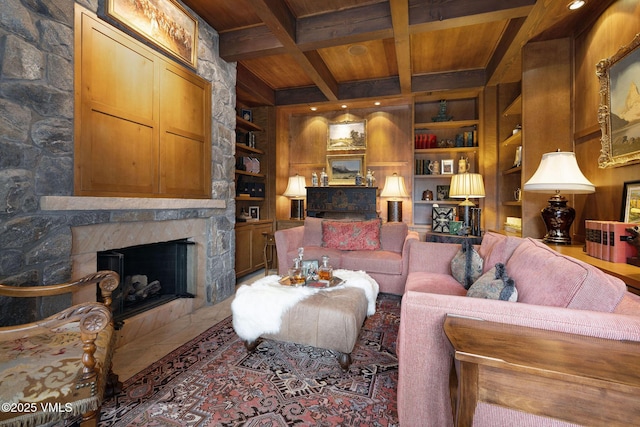 780 Potato Patch Dr, Vail, CO 81657 - living area with built in features, a wooden ceiling with exposed beams, a stone fireplace, and coffered ceiling