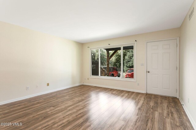 600 Price Ln Unit 1, Gypsum, CO 81637 - living area featuring wood finished floors, a multi sided fireplace, and a textured ceiling