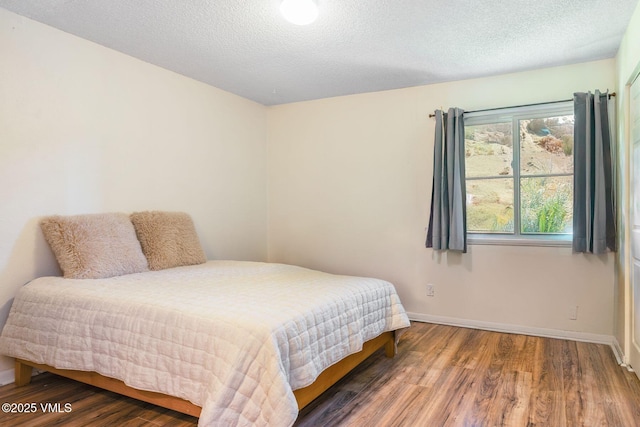 600 Price Ln Unit 1, Gypsum, CO 81637 - bedroom featuring wood finished floors and a textured ceiling