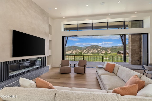 0599 Gray Rock Dr, Eagle, CO 81631 - living room featuring wood finished floors, recessed lighting, a glass covered fireplace, and a high ceiling