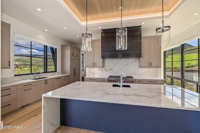 0599 Gray Rock Dr, Eagle, CO 81631 - kitchen with wall chimney exhaust hood, a tray ceiling, modern cabinets, plenty of natural light, and recessed lighting