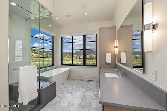 0599 Gray Rock Dr, Eagle, CO 81631 - full bath with plenty of natural light, a freestanding tub, marble finish flooring, vanity, and recessed lighting