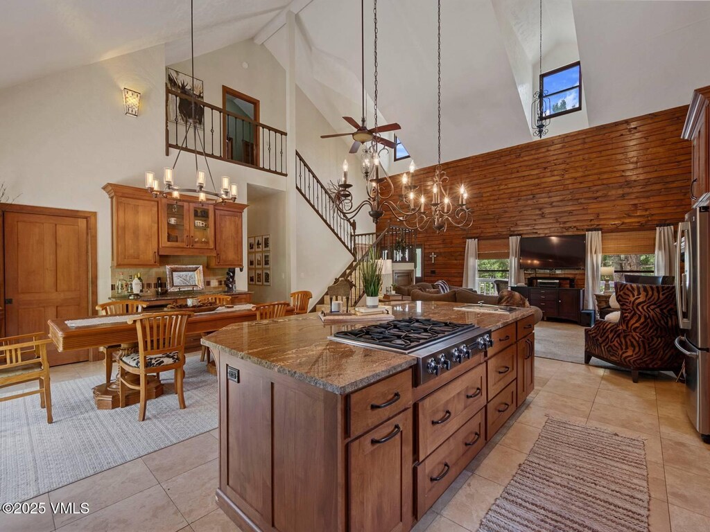 2040 Mullenville Rd, Fairplay, CO 80440 - kitchen featuring stainless steel appliances, high vaulted ceiling, open floor plan, brown cabinets, and a chandelier