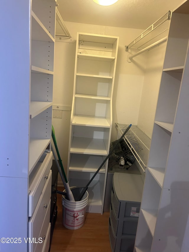 spacious closet with wood finished floors