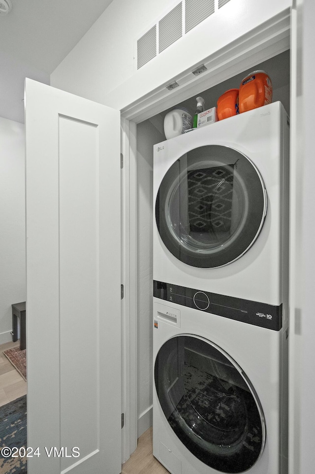 laundry area with stacked washing maching and dryer