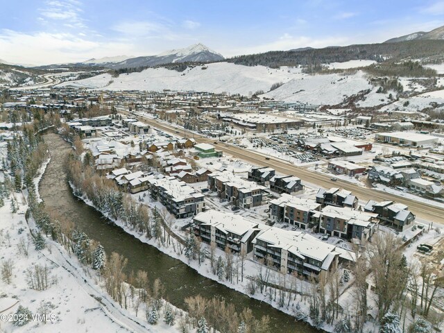 snowy aerial view with a mountain view