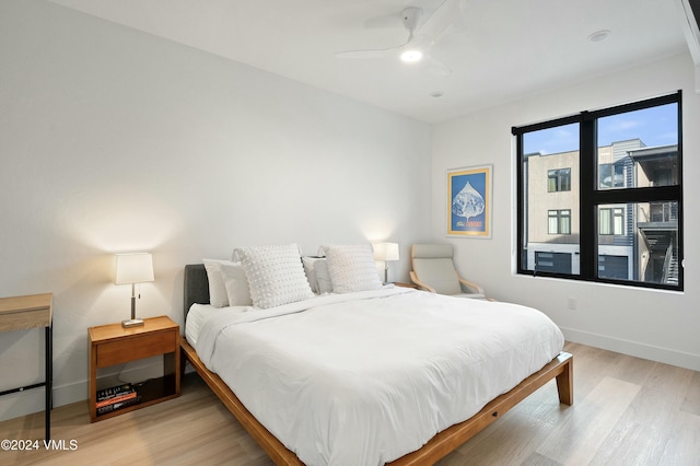 bedroom with ceiling fan and light wood-type flooring