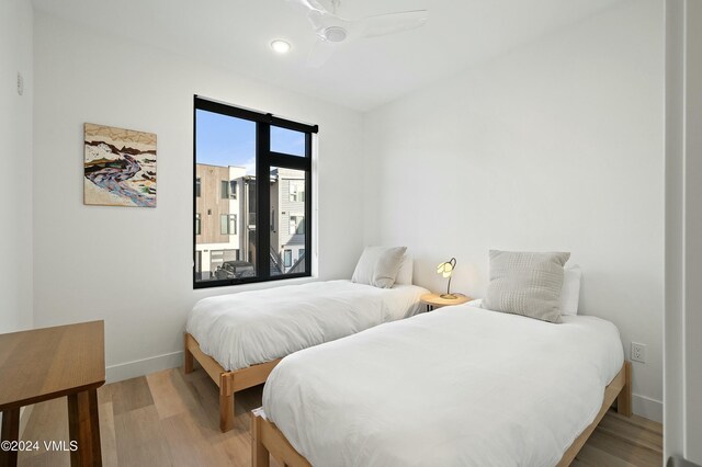 bedroom featuring ceiling fan, wood-type flooring, and access to exterior