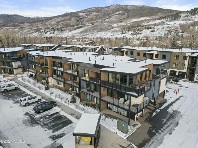 snowy aerial view featuring a mountain view