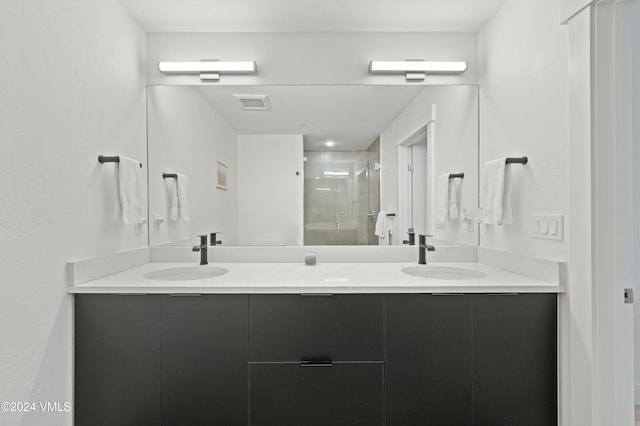 bathroom featuring vanity and a shower with shower door