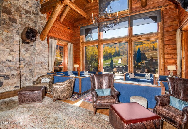 sunroom featuring beamed ceiling, a notable chandelier, and wood ceiling