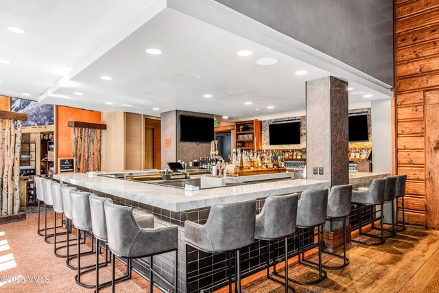 bar featuring light hardwood / wood-style floors