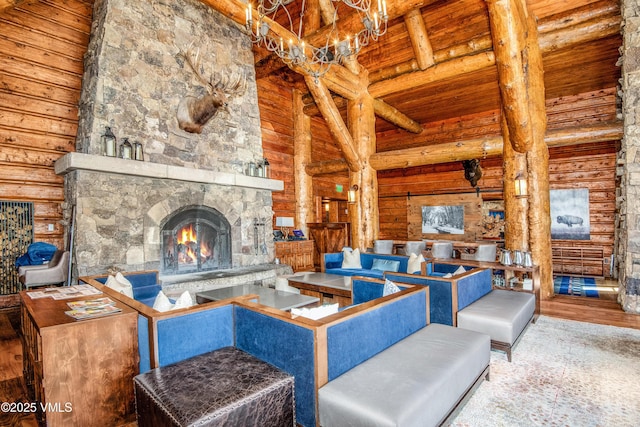 living room featuring a fireplace, hardwood / wood-style flooring, beam ceiling, wood ceiling, and high vaulted ceiling