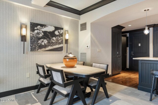 dining area featuring wood-type flooring, beamed ceiling, and wooden ceiling