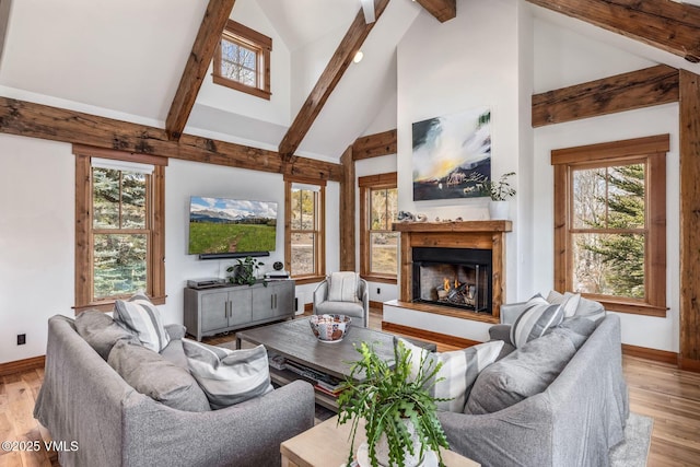 674 Hernage Creek Rd, Eagle, CO 81631 - living room with a glass covered fireplace, beamed ceiling, high vaulted ceiling, baseboards, and healthy amount of natural light