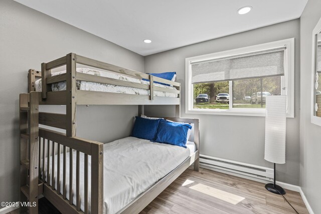 1061 W Beaver Creek Blvd Unit F101, Avon, CO 81620 - bedroom with a baseboard heating unit, wood finished floors, baseboards, and recessed lighting