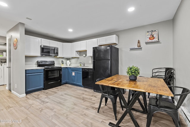 1061 W Beaver Creek Blvd Unit F101, Avon, CO 81620 - kitchen featuring black appliances, separate washer and dryer, blue cabinets, baseboard heating, and light countertops