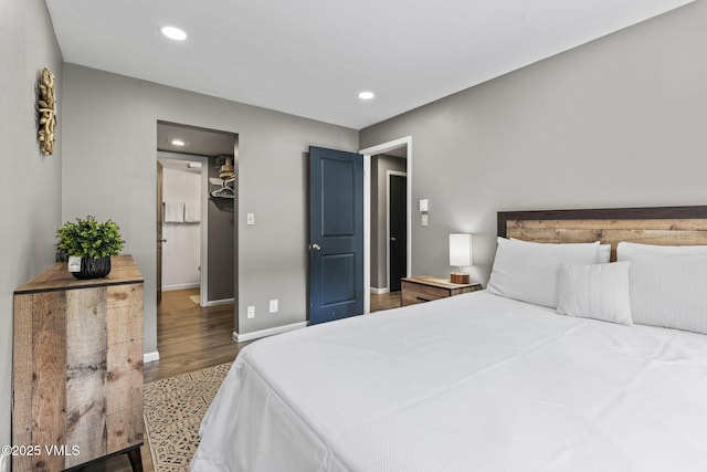 1061 W Beaver Creek Blvd Unit F101, Avon, CO 81620 - bedroom featuring wood finished floors, recessed lighting, a walk in closet, and baseboards