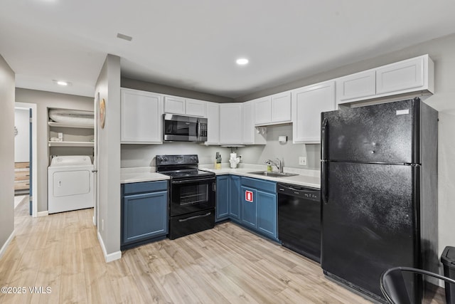1061 W Beaver Creek Blvd Unit F101, Avon, CO 81620 - kitchen with black appliances, a sink, blue cabinets, independent washer and dryer, and white cabinets