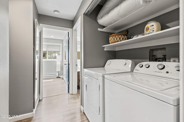 1061 W Beaver Creek Blvd Unit F101, Avon, CO 81620 - laundry room featuring a baseboard radiator, light wood-type flooring, baseboards, and separate washer and dryer