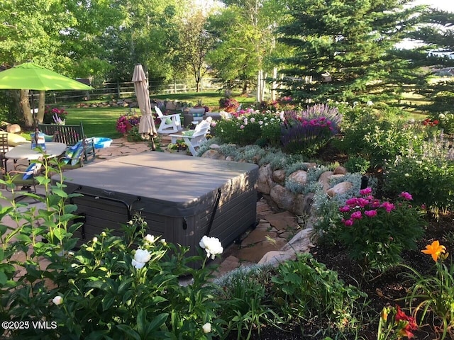 view of yard featuring a hot tub and fence