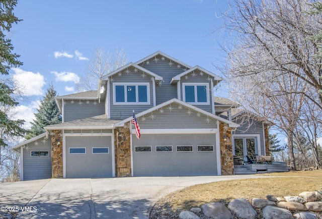 craftsman house featuring an attached garage, stone siding, driveway, and a shingled roof