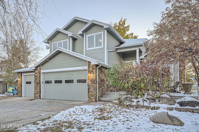 view of front of home with stone siding and driveway