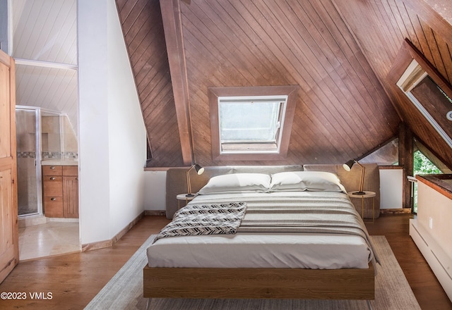 bedroom with a baseboard heating unit, connected bathroom, wood finished floors, wooden walls, and lofted ceiling