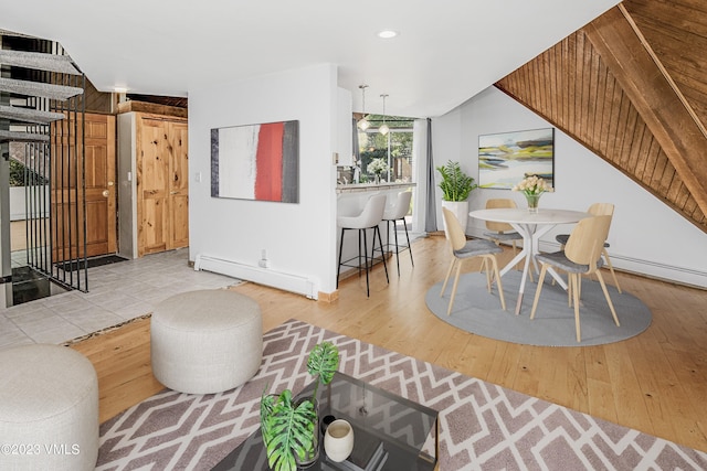 living area featuring recessed lighting, light wood-style flooring, and baseboard heating