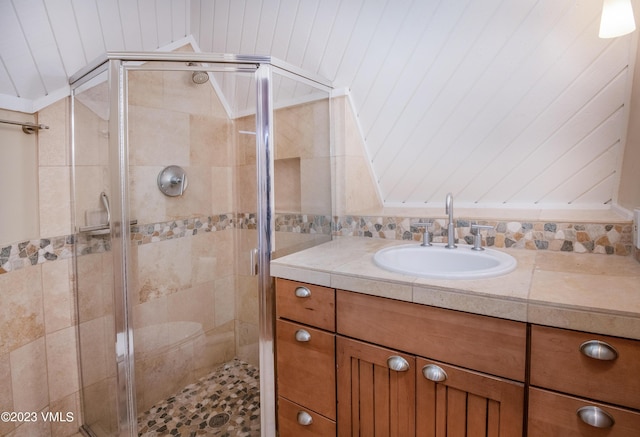 bathroom with a shower stall and vanity