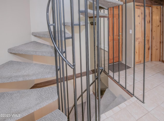 staircase with tile patterned flooring