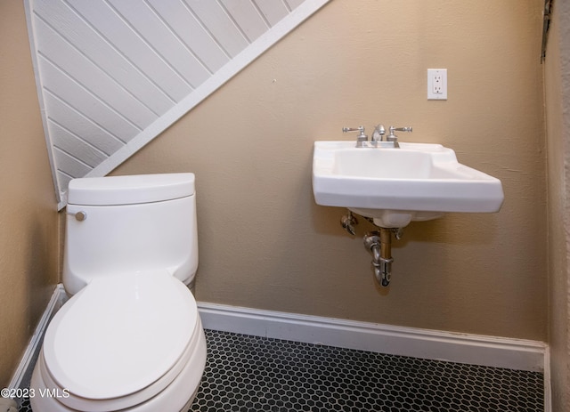 half bathroom featuring toilet