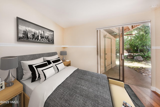 bedroom with wood finished floors and access to outside