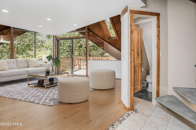 living room featuring recessed lighting, wood finished floors, and a wall of windows