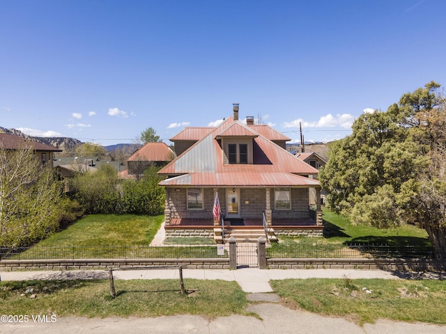 409 Washington St, Eagle, CO 81631 - bungalow with a porch, a chimney, a gate, and metal roof