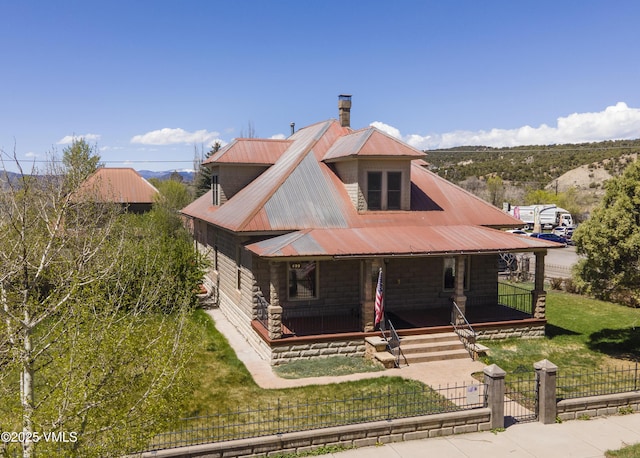 409 Washington St, Eagle, CO 81631 - view of front of property featuring covered porch, a gate, metal roof, and a chimney