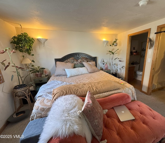 409 Washington St, Eagle, CO 81631 - carpeted bedroom featuring a baseboard heating unit, baseboards, and ensuite bathroom