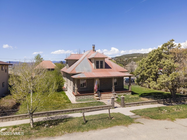 409 Washington St, Eagle, CO 81631 - view of front of home featuring covered porch, a chimney, and metal roof