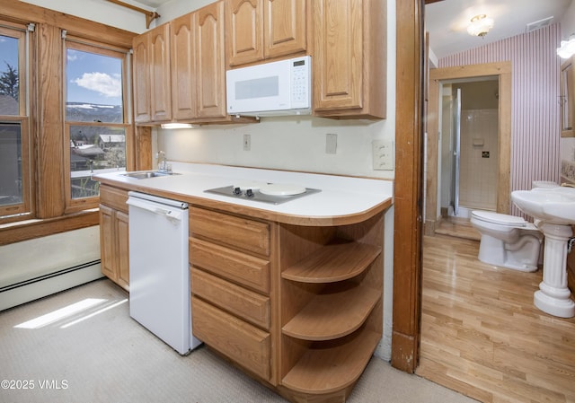 409 Washington St, Eagle, CO 81631 - kitchen with white appliances, a sink, a baseboard radiator, light countertops, and open shelves