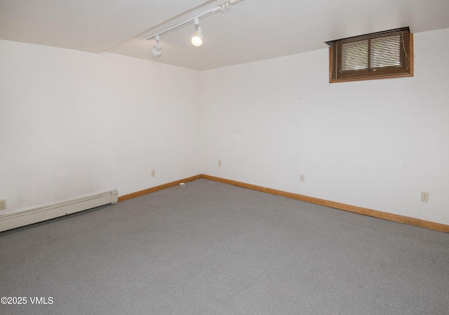 409 Washington St, Eagle, CO 81631 - empty room with carpet floors, track lighting, a baseboard heating unit, and baseboards
