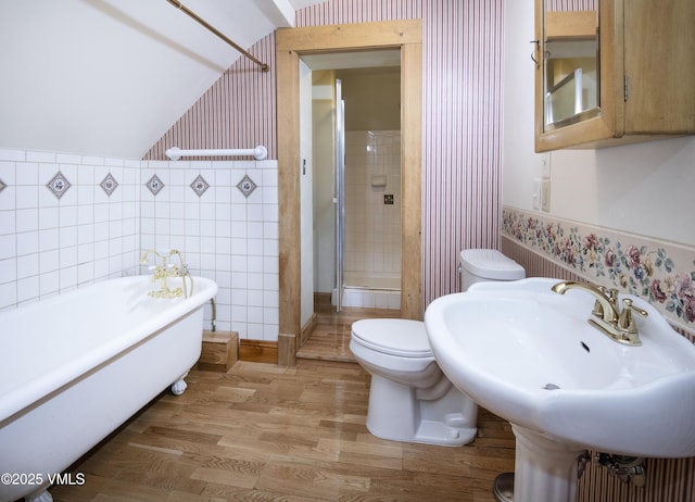 409 Washington St, Eagle, CO 81631 - bathroom featuring wallpapered walls, a freestanding tub, toilet, a shower stall, and wood finished floors