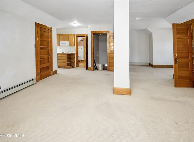 409 Washington St, Eagle, CO 81631 - basement featuring a baseboard heating unit, light carpet, and baseboard heating