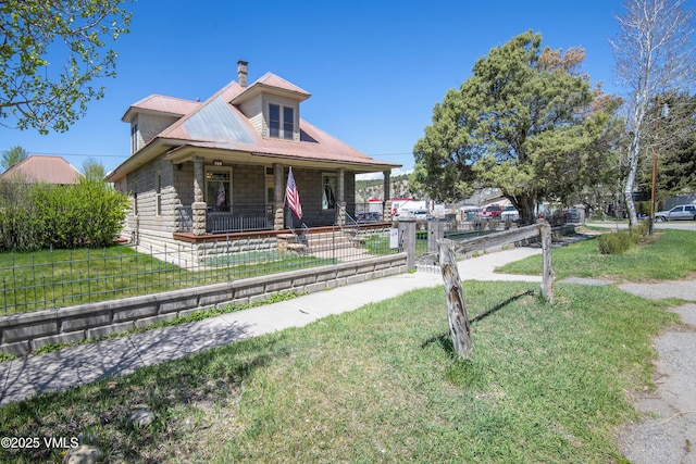 409 Washington St, Eagle, CO 81631 - view of front of property with covered porch, metal roof, a chimney, and stone siding