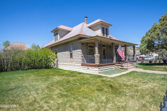 409 Washington St, Eagle, CO 81631 - view of front of house featuring covered porch, a front lawn, a chimney, and metal roof