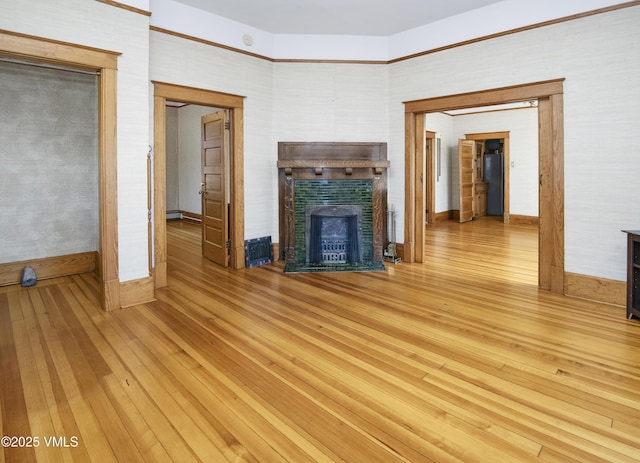 409 Washington St, Eagle, CO 81631 - unfurnished living room with light wood-type flooring, a fireplace with flush hearth, and baseboard heating