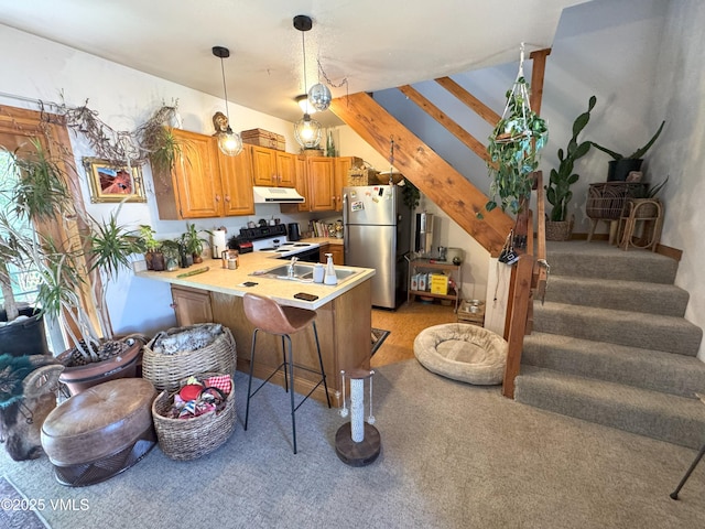 409 Washington St, Eagle, CO 81631 - kitchen with freestanding refrigerator, white range with electric cooktop, a peninsula, light colored carpet, and under cabinet range hood