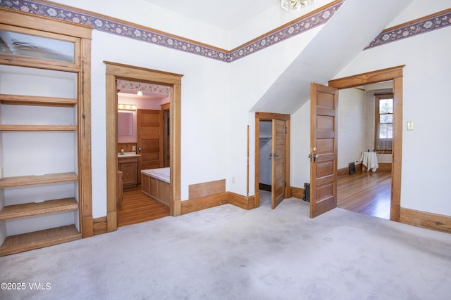 409 Washington St, Eagle, CO 81631 - unfurnished bedroom featuring carpet flooring, lofted ceiling, a sink, baseboards, and ensuite bathroom