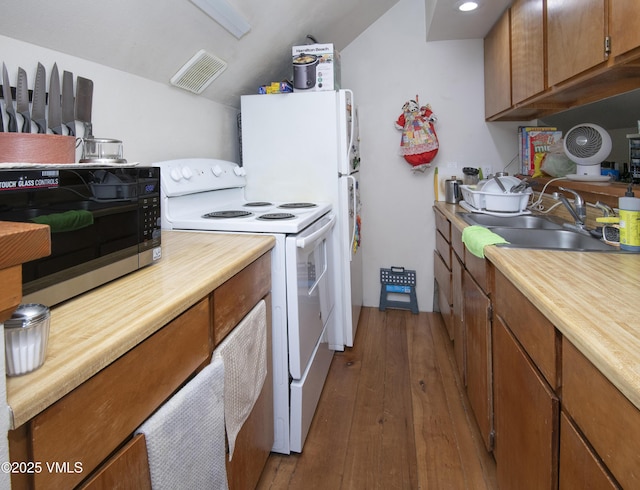 409 Washington St, Eagle, CO 81631 - kitchen with white appliances, a sink, dark wood finished floors, and brown cabinetry